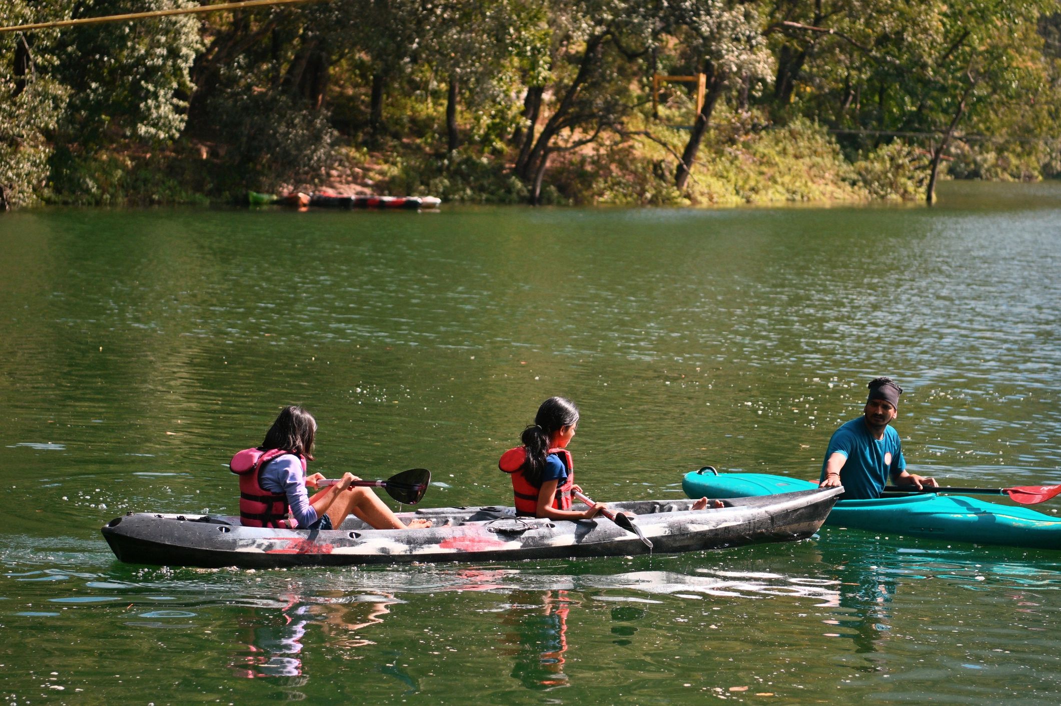 Guests kayaking on a peaceful lake
